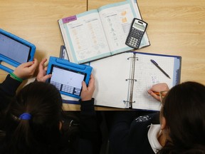 Loretto College Grade 9 students use tablets to do their math lessons in class. (Jack Boland/Toronto Sun/Postmedia Network)