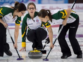 Northern Ontario skip Krista McCarville, centre, makes a shot as lead Sarah Potts and second Ashley Sippala sweep during the page semifinal against Team Canada at the Scotties Tournament of Hearts in Grande Prairie, Alta. Saturday, Feb. 27, 2016. (THE CANADIAN PRESS/Jonathan Hayward)