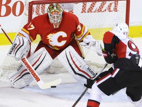 Calgary Flames goalie Joni Ortio stops Ottawa Senators Mike Zibanejad in NHL hockey action at the Scotiabank Saddledome in Calgary, Alta. on Saturday February 27, 2016. (Mike Drew/Postmedia)