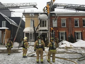 Firefighters evacuated neighbours as they tackled a house fire on Booth Street early Sunday morning, Feb. 28, 2016. (Chris Roussakis/Postmedia Network)