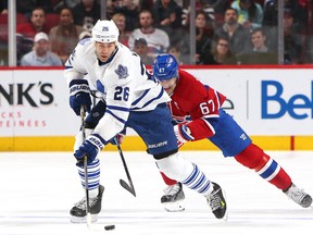 Toronto Maple Leafs right wing Daniel Winnik (26) plays the puck against Montreal Canadiens left wing Max Pacioretty (67) during the third period at Bell Centre Feb 27, 2016 in Montreal. (Jean-Yves Ahern-USA TODAY Sports)