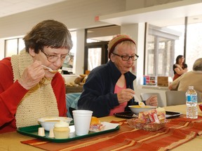 Mary Jane Green (left) and Janet Brown Lynn sample the roasted red pepper and curried potato soup offered at this  year's Empty Bowls fundraiser held at Loyalist College.