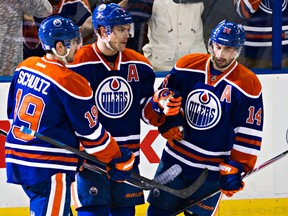 Taylor Hall and Jordan Eberle, seen here celebrating a goal with Justin Schultz, say they can understand fans booing the team but when it's a single player, it's tough to take. (File)