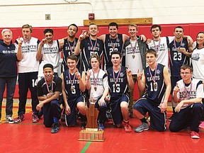 Quinte Saints celebrate their COSSA AA senior boys basketball title.