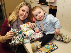 John Lappa/Sudbury Star
Kayla Pelland, owner/operator of a cloth diaper rental service, and her daughter, Pandora, 1, show some of the colourful diapers that are available.