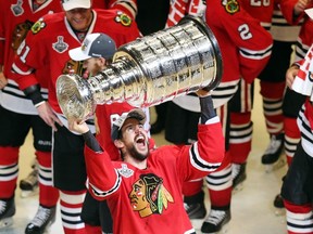 Antoine Vermette #80 of the Chicago Blackhawks celebrates by hoisting the Stanley Cup after defeating the Tampa Bay Lightning by a score of 2-0 in Game 6 to win the 2015 NHL Stanley Cup Final at the United Center on June 15, 2015 in Chicago, Illinois.   Jonathan Daniel/Getty Images/AFP