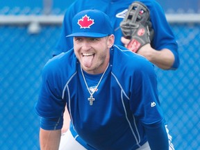 Toronto Blue Jays third baseman Josh Donaldson sticks out his tongue while waiting for a ground ball during baseball spring training in Dunedin, Fla., on Tuesday, February 24, 2015. THE CANADIAN PRESS/Nathan Denette