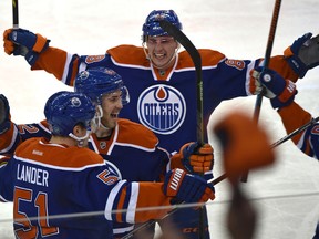 Anton Lander celebrates his goal against the Islanders with his linemates Sunday at Rexall Place. (Ed Kaiser)