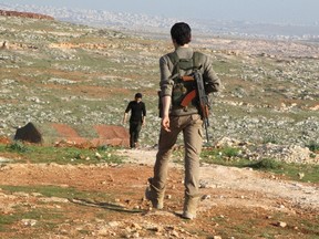 Ahrar Souriya brigade fighters, part of the Free Syrian Army, walk in al-Tamorah village mountains near the villages of Nubul and al-Zahraa, northern Aleppo countryside, Syria February 28, 2016. REUTERS/Abdalrhman Ismail