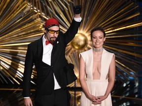 Sacha Baron Cohen, left, and Olivia Wilde speak at the Oscars on Sunday, Feb. 28, 2016, at the Dolby Theatre in Los Angeles. (Photo by Chris Pizzello/Invision/AP)