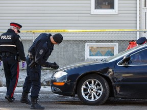 Edmonton Police Service officers investigate after a shooting involving multiple suspects near 159 Street and 103 Avenue on Sunday, Feb. 29, 2016. Police say the shooting occurred after a collision between a black Honda Civic and a black Chrysler 300 in the area. (Ian Kucerak Photo)