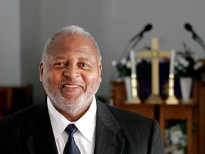 In this January 2011 photo, the Rev. William B. Schooler poses for a photo in Dayton, Ohio. The pastor with deep roots in the Dayton community was shot and killed at his church Sunday, Feb. 28, 2016, and police say they expect to charge his brother, Daniel Gregory Schooler, in the slaying on Monday. (Chris Stewart/Dayton Daily News via AP)