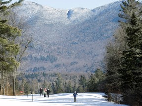 In this Jan. 28, 2015 file photo, people cross-country ski in Lake Placid, N.Y. When it comes to winter sports, New Yorkers often pick Vermont over their own state, but New York is trying to promote the Catskills and Adirondacks as premier winter destinations. (AP Photo/Mel Evans, File)