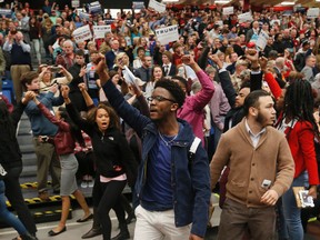 Protesters are escorted out of a rally for Republican presidential candidate, Donald Trump at Radford University in Radford, Va., Monday, Feb. 29, 2016. (AP Photo/Steve Helber)