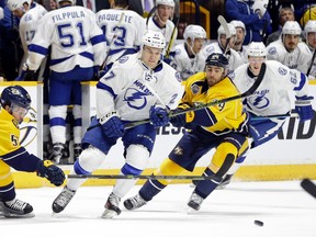 Tampa Bay Lightning left winger Jonathan Drouin battles with Nashville Predators' Gabriel Bourque and Eric Nystrom for the puck in Nashville on Oct. 20, 2015. (AP Photo/Mark Humphrey)