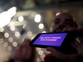 A man displays a protest message on his iPhone at a small rally in support of Apple's refusal to help the FBI access the cell phone of a gunman involved in the killings of 14 people in San Bernardino, in Santa Monica, California, United States.  (REUTERS/Lucy Nicholson/Files)