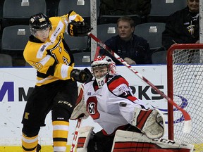Kingston Frontenacs' Spencer Watson deflects a shot wide of Ottawa 67's goalie Leo Lazarev during Ontario Hockey League action at the Rogers K-Rock Centre on Monday. (Ian MacAlpine /The Whig-Standard)