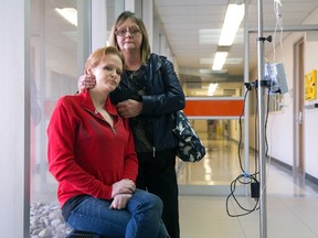 Lisa Fay, 31, sits by a window at University Hospital where she has been admitted, with help from her aunt, Lorraine Fay, after being kicked out of Victoria Hospital for injecting herself while being treated for a heart valve infection. (CRAIG GLOVER, The London Free Press)