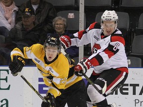 Kingston Frontenacs' Ted Nichol (left) is crosschecked by Ottawa 67's Ryan Orban during Ontario Hockey League action in Kingston on Monday night. (Ian MacAlpine /Postmedia Network)