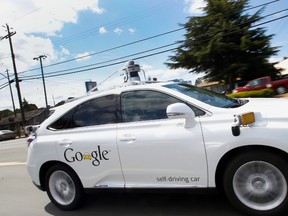 In this May 13, 2015, file photo, Google's self-driving Lexus car drives along street during a demonstration at Google campus in Mountain View, Calif. A self-driving car being tested by Google struck a public bus on a city street, a fender-bender that appears to be the first time one of the tech company's vehicles caused an accident. The collision occurred on Valentine's Day and Google reported it to California's Department of Motor Vehicles in an accident report that the agency posted Monday, Feb. 29. (AP Photo/Tony Avelar, File)