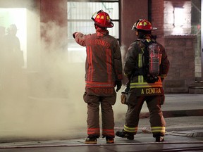 Toronto firefighters battle an underground hydro vault fire on Richmond St. E., near Church St., on March 1, 2016. The fire led to a halt in TTC subway and streetcar service for hours. (John Hanley/Special to the Toronto Sun)