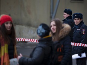 Russian police officers secure an area near to a subway station in Moscow on Monday, Feb. 29, 2016. Russian news agencies report that police have arrested a woman who was waving the severed head of a small child outside a Moscow subway station. The Investigative Committee released a statement saying a woman was arrested Monday on suspicion of killing a child aged 3 or 4 in an apartment near the metro station in northwestern Moscow and then setting the apartment on fire.  (AP Photo/Alexander Zemlianichenko)