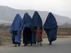Afghan women walk along a street on the outskirts of Kabul, Afghanistan March 1, 2016. REUTERS/Omar Sobhani