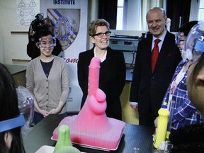 EXCITED ABOUT FREE TUITION: Premier Kathleen Wynne gets an eyeful as a science experiment produces interesting results at Jarvis Collegiate in Toronto on March 1, 2016.