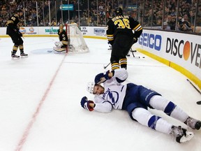 Lightning's Cedric Paquette (13) lies on the ice as Bruins' Zac Rinaldo (36) skates away during first period NHL action in Boston on Feb. 28, 2016. Rinaldo has been suspended for five games for an illegal check to the head. (Michael Dwyer/AP Photo)