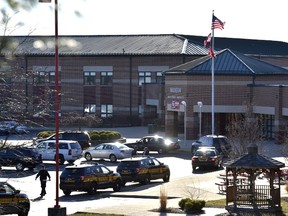 Butler County Sheriff Deputies stand on the scene at Madison Local Schools, Monday, Feb. 29, 2016, in Madison Township in Butler County, Ohio, after a school shooting. (Nick Graham/Dayton Daily News via AP)