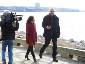 Rob Calabrese (right), of the Giant 101.9 radio station and creator of the website (cbiftrumpwins.com) walks with CNN reporter Paula Newton during an election piece for her news organization in Sydney, N.S., Tuesday, March 1, 2016. (THE CANADIAN PRESS/Vaughan Merchant)
