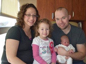 Chad and Melissa Croff pose with their their newborn Evelyn Joy and Eliana Adaya, center left, at Henry Ford Macomb Hospital in Clinton Township, Mich. (Henry Ford Health System via AP)