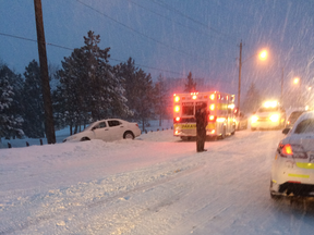 Paramedics attend to a man stranded in Ottawa's record breaking snowstorm on Feb 16. STEPHEN BELANGER