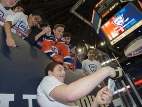 Ryan Nugent-Hopkins  takes a selfie with kids waiting for autographs as 2,000 junior high-school students watched the launch of the Hockey Helps Kids Charity Cup last week. (Shaughn Butts)