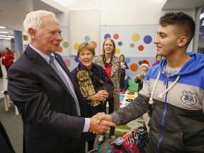 The Governor General of Canada David Johnston greets Syrian refugees at the Pearson Toronto International Airport in Mississauga, Ontario, December 18, 2015.    REUTERS/Mark Blinch