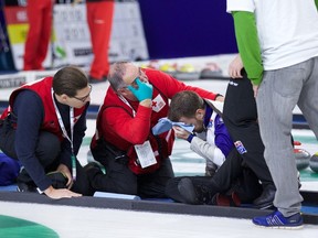 First-aid workers attend to Newfoundland and Labrador skip Brad Gushue after he tumbled to the ice during a Grand Slam event in Nova Scotia in October. (Anil Mungal, Sportsnet)