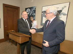 Premier Greg Selinger (right) is losing caucus members like Ron Lemieux left and right.
