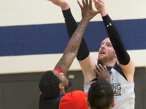 Nick Evans puts up a shot under pressure during a scrimmage at practice with his new team, the London Lightning, on Tuesday. (DEREK RUTTAN, The London Free Press)