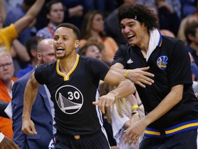 Warriors’ Stephen Curry (left) celebrates after hitting the game-winning shot in overtime against the Thunder on Saturday. (AP)