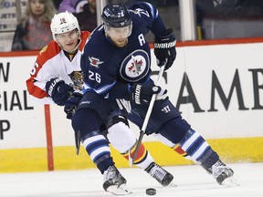 Mar 1, 2016; Winnipeg, Manitoba, CAN; Florida Panthers center Aleksander Barkov (16) defends Winnipeg Jets right wing Blake Wheeler (26) during a first period at MTS Centre. Mandatory Credit: Bruce Fedyck-USA TODAY Sports