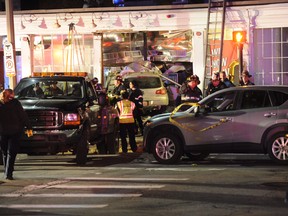 Emergency responders stand on the scene after a vehicle crashed into Sweet Tomatoes Pizza restaurant killing several people in Newton, Mass., Tuesday, March 1, 2016. (Christopher Evans/The Boston Herald via AP)