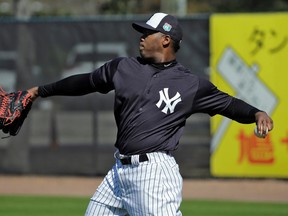 In this Feb. 19, 2016, file photo, New York Yankees pitcher Aroldis Chapman throws during a spring training baseball workout, in Tampa, Fla. Aroldis Chapman agreed to accept a 30-game suspension under Major League Baseball’s domestic violence policy, a penalty stemming from an incident with his girlfriend last October.  Under the discipline announced Tuesday, March 1, 2016, Chapman will serve the penalty from the start of the season in April. (AP Photo/Chris O'Meara)