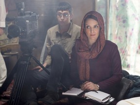 In this image released by Paramount Pictures, Nicholas Braun portrays Tall Brian, left, and Tina Fey portrays Kim Baker in a scene from "Whiskey Tango Foxtrot." (Frank Masi/Paramount Pictures and Broadway Video/Little Stranger Productions)