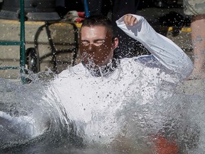 POSTMEDIA NETWORK File photo
Correctional peace officer Brad Van Massenhoven, dressed as Hannibal Lecter, splashed down during the Freezin' for a Reason Polar Pluge in Arbour Lake in Calgary, Alta., on Sunday March 16, 2014. A similar event will take place in Belleville this Saturday with funds raised going toward the YMCA’s Strong Kids campaign.