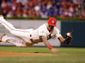 St. Louis Cardinals second baseman Kolten Wong dives for a ball during Game 2 of the National League Division Series against the Chicago Cubs Saturday, Oct. 10, 2015, in St. Louis. (AP Photo/Jeff Roberson)