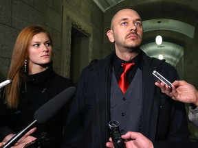 Jamie Hall, Manitoba Liberal candidate for Southdale, speaks to media about a social media post shown to him on a reporter's phone at the Manitoba Legislature on Wed., March 2, 2016. Girlfriend Dez Joyal is at his side. Kevin King/Winnipeg Sun/Postmedia Network