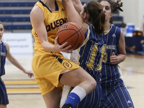 Queens Gaels' Jenny Wright, a graduate of the Regiopolis-Notre Dame Panthers, goes up for a basket against Laurentian Voyageurs' Mackenzie Robinson during OUA women's basketball playoff action at the Queen's Athletics and Recreation Centre Wednesday night. (Ian MacAlpine/The Whig-Standard)
