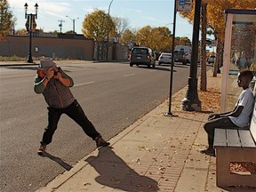 Italian photographer Leonardo Autera is seen photographing a person at an Edmonton bus stop. Autear, 55, and Cynthia Zambrano, 38, have been charged by police in connection to a a vandalism spree that saw numerous bus shelters destroyed with broken and shattered glass. FILE PHOTO