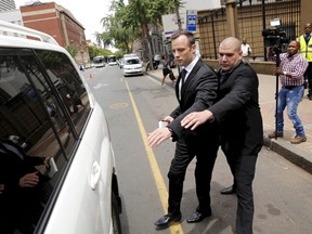 Oscar Pistorius (left) leaves the North Gauteng High Court in Pretoria, South Africa after his bail hearing, in this December 8, 2015 file photo. Pistorius cannot challenge his conviction for the murder of girlfriend Reeva Steenkamp, a spokesman for the prosecuting authorities said on March 3, 2016. (Sydney Seshibedi/Reuters/Files)
