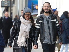 In this Tuesday, March 1, 2016, photo, Nicole DePinto, left, and her husband, Anthony, pose for a photo, in New York. DePinto raised $2,900 on crowdfunding site GoFundMe for an Icelandic honeymoon for the couple. Websites such as Honeyfund, GoFundMe and Honeymoon Wishes make it easy to raise cash for a post-wedding getaway. (AP Photo/Mary Altaffer)